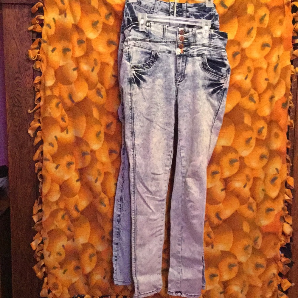 Two pairs of acid washed high waisted  jeans.